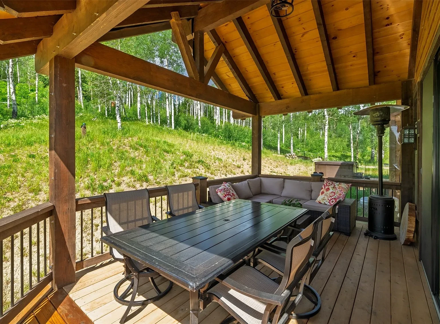 Outdoor hot tub and deck at evening with mountain views