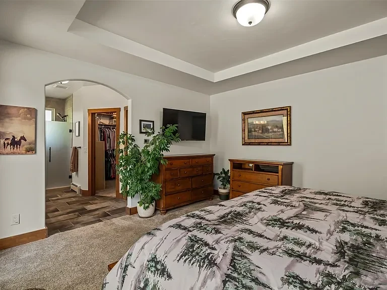 Mountain home bedroom with floor-to-ceiling windows and mountain views