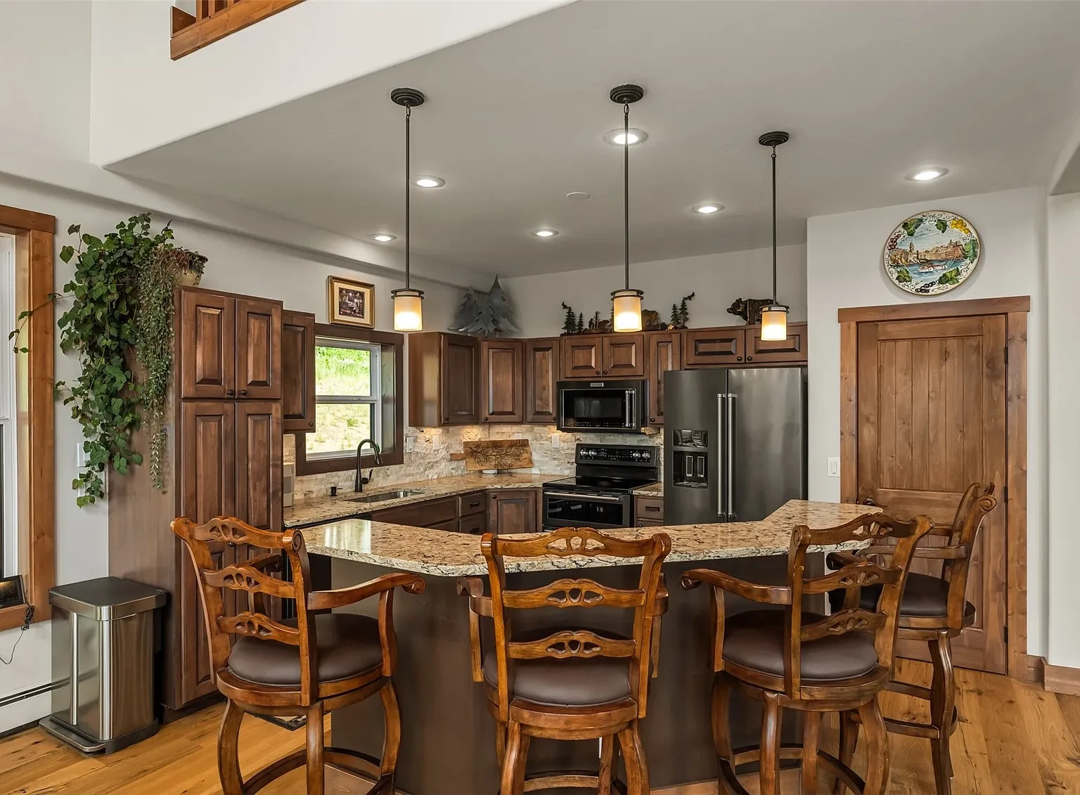 Modern rustic mountain home kitchen with warm wood and stone finishes