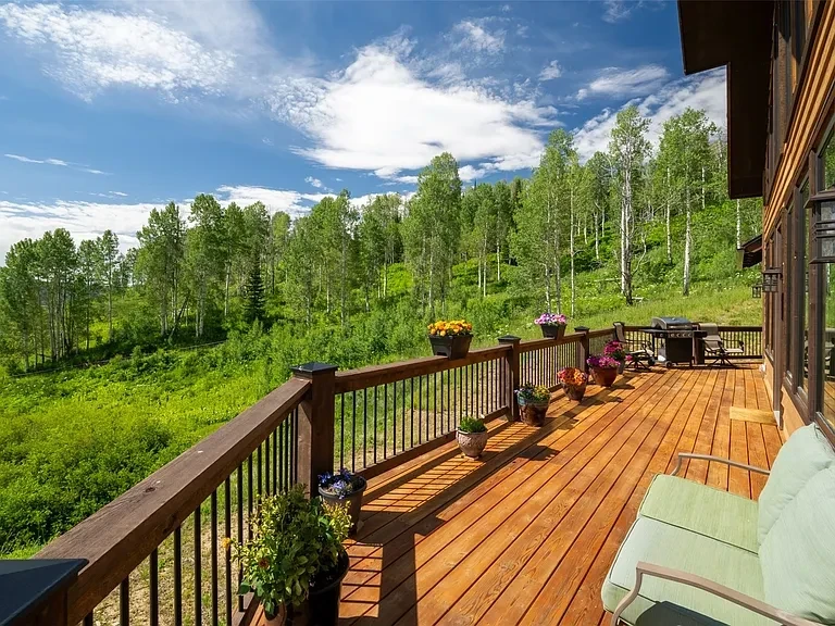 Mountain home outdoor deck with sweeping Rocky Mountain views